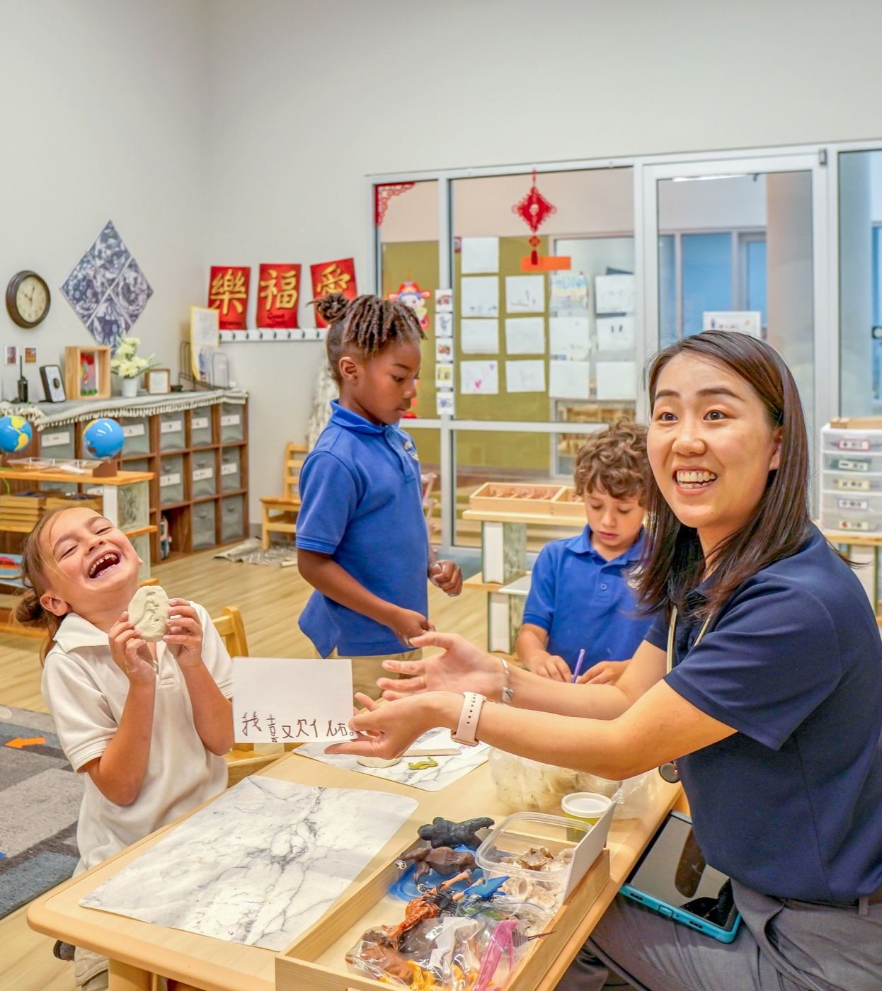 ILIM guide sharing a hands-on activity with smiling students